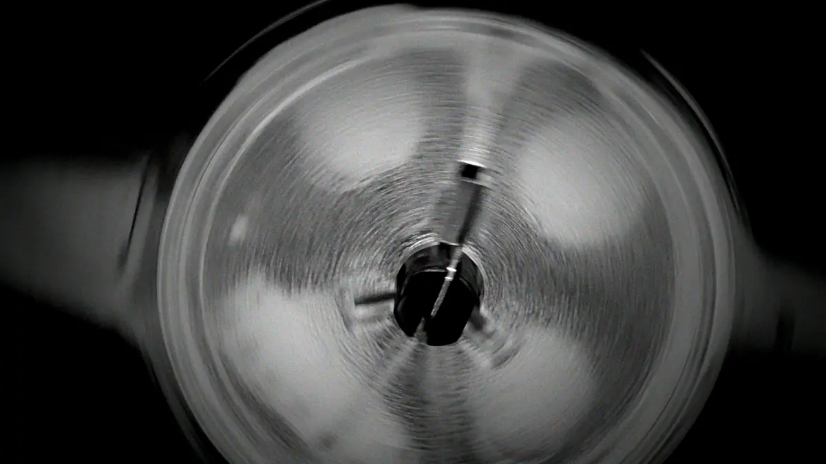 Black and white close-up of a spinning film reel